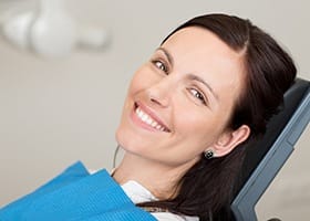 Smiling woman in dental chair during dental checkup in Oklahoma City