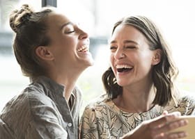 Two young women laughing together