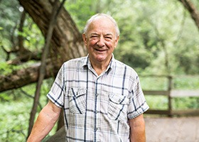 older man smiling outdoors with dentures in Oklahoma City