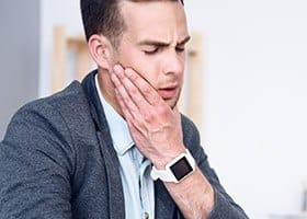 Man holding his jaw in pain