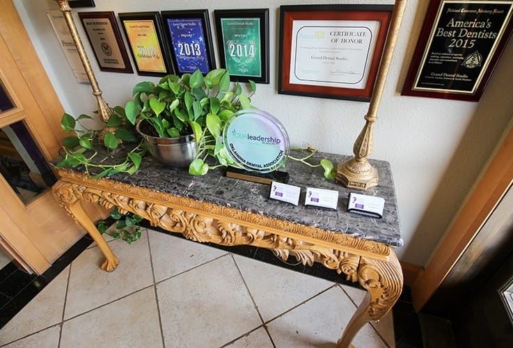 Table and wall with awards and plaques in Oklahoma City dental office