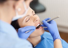 Relaxed woman receiving dental treatment after sedation dentistry in Oklahoma City