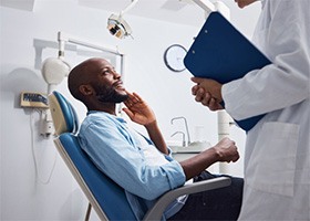 male patient talking to dentist 