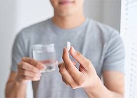 young man taking pill 