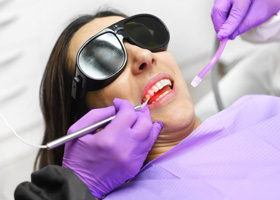 Young woman receiving laser dentistry
