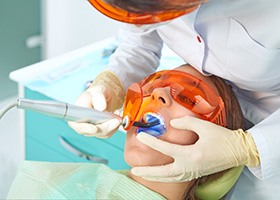 Dentist curing a tooth-colored filling