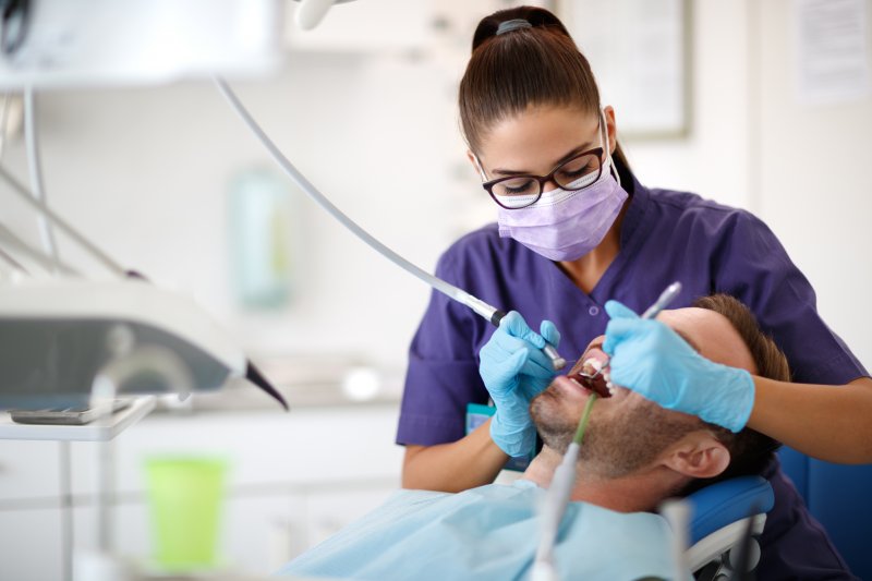 hygienist cleaning a patient’s teeth 